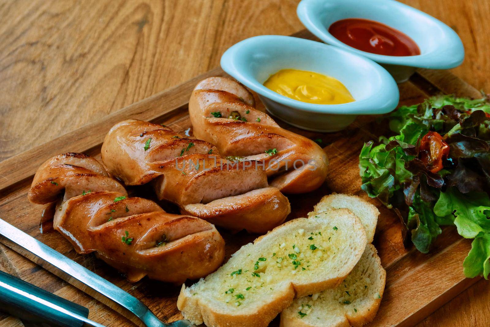 delicious mixed pork sausage with salad and garlic bread by baworn47