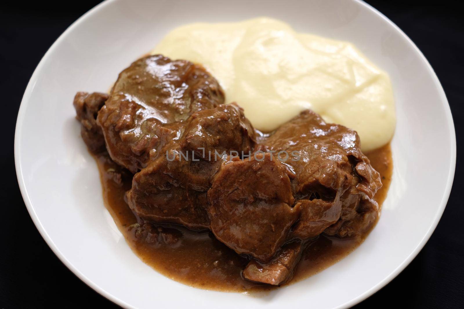 beef stew and mash potato with black background