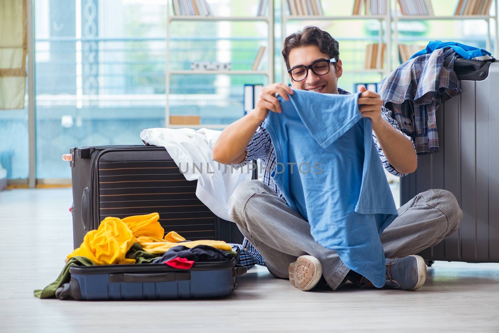 Young man preparing for vacation travel by Elnur