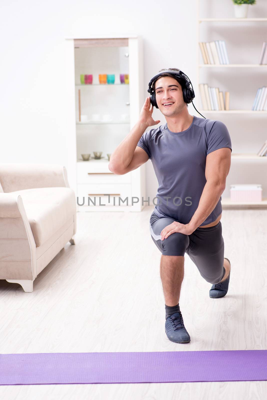 Man doing sports at home and listening to music