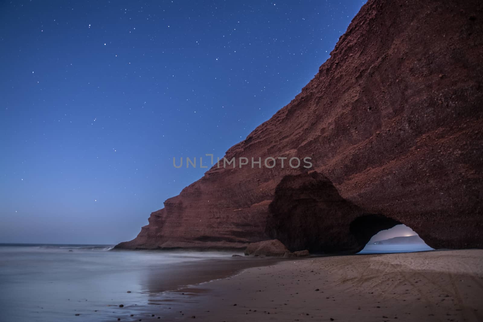 Landscape of Legzira Beach with its natural arches at the coast of Atlantic ocean. Legzira Beach is located on the ocean coast of Morocco, in Sidi Ifni, close to Agadir.
