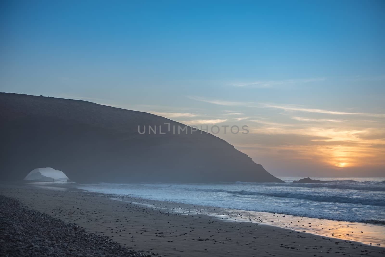 Landscape of Legzira Beach with its natural arches at the coast of Atlantic ocean. Legzira Beach is located on the ocean coast of Morocco, in Sidi Ifni, close to Agadir.