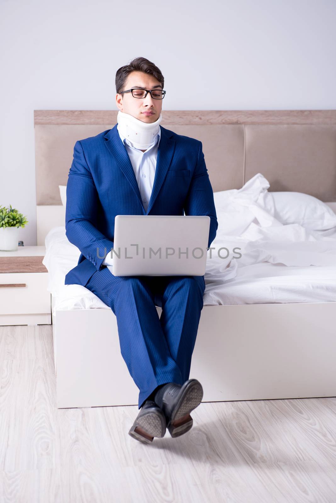 Businessman with neck injury working from home