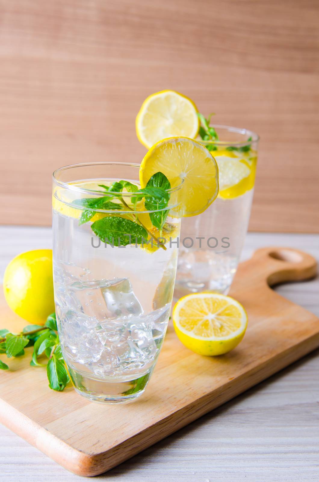 Glasss of mojito with lemon and drinking straw