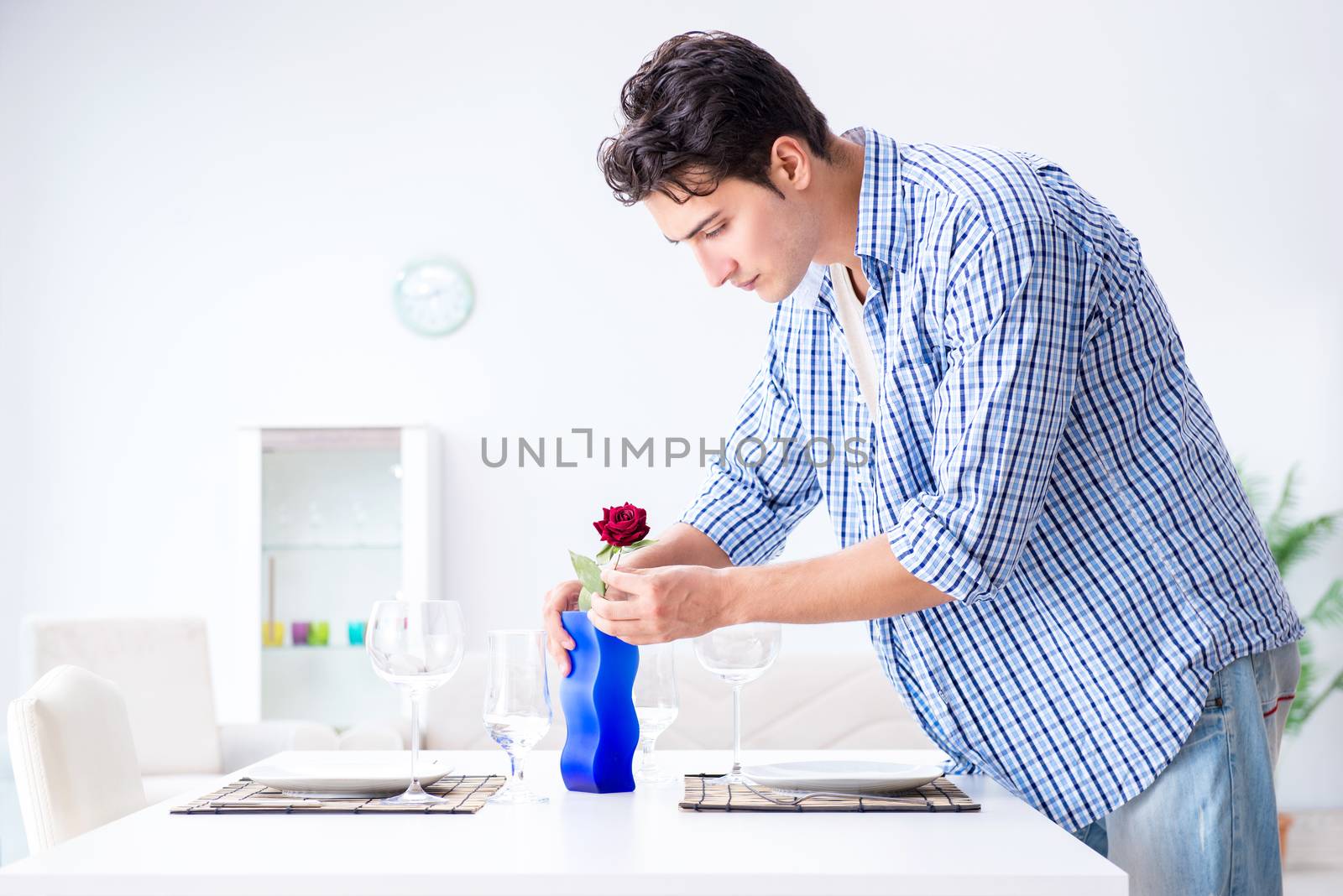 Man alone preparing for romantic date with his sweetheart