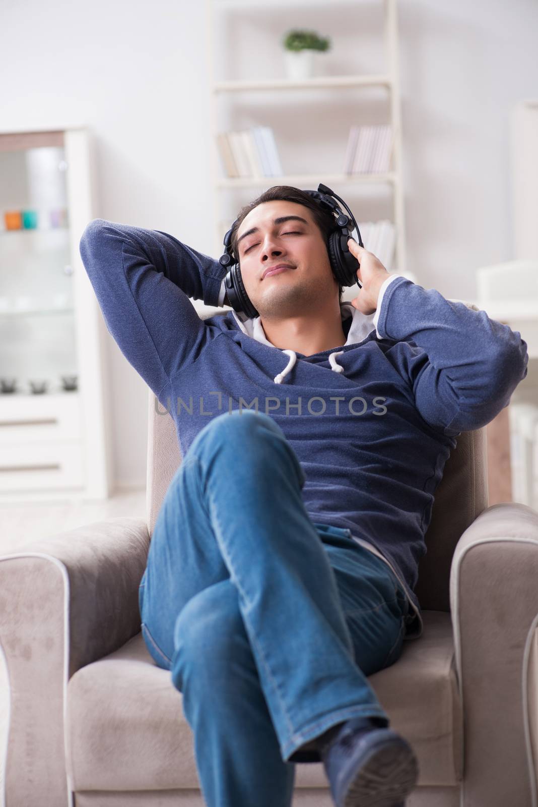 Young man listening to music at home