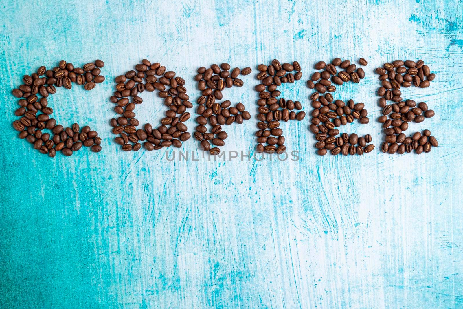 Roasted coffee grains on aquamarine background by eagg13