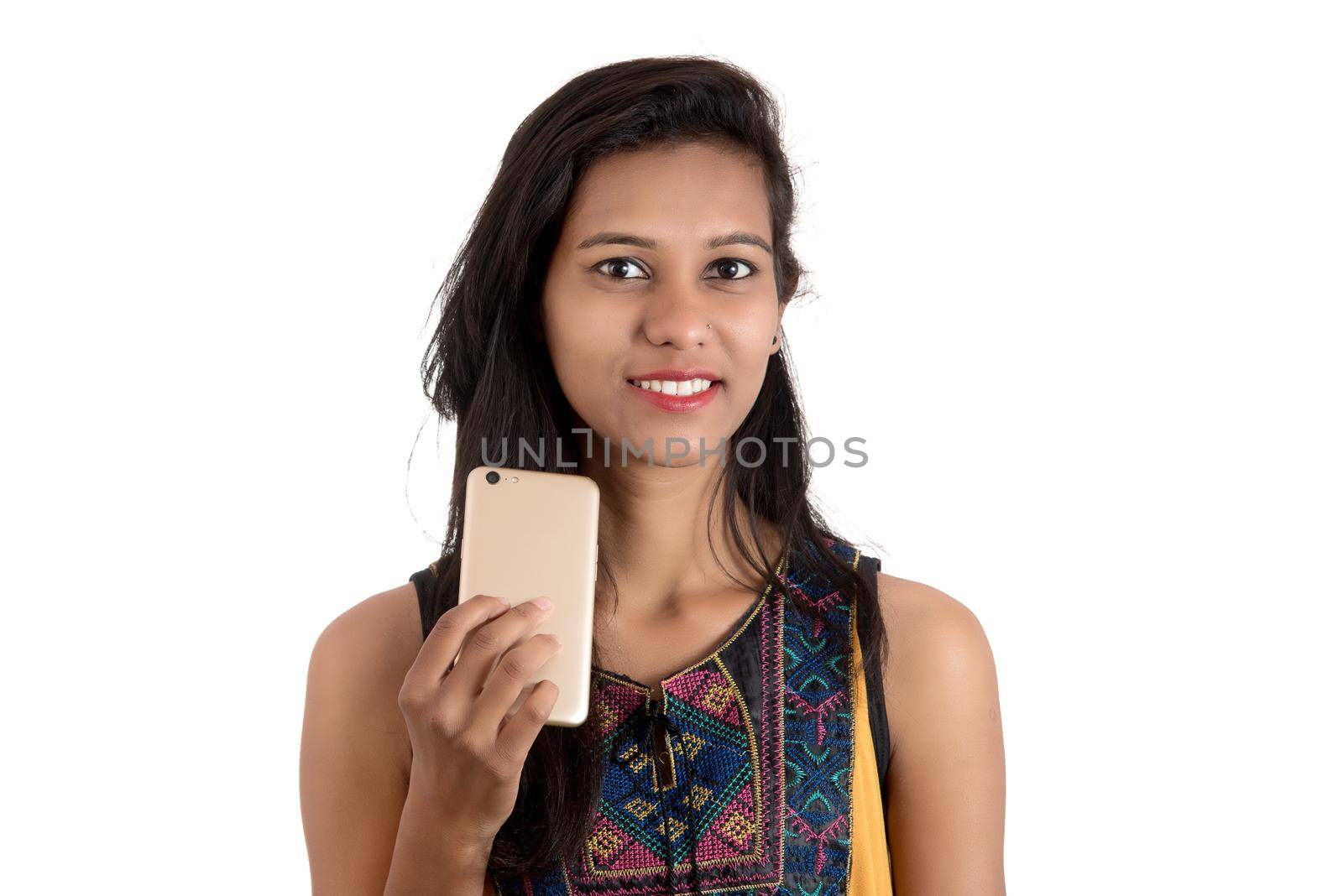 Portrait of a happy young girl using mobile phone isolated over white background