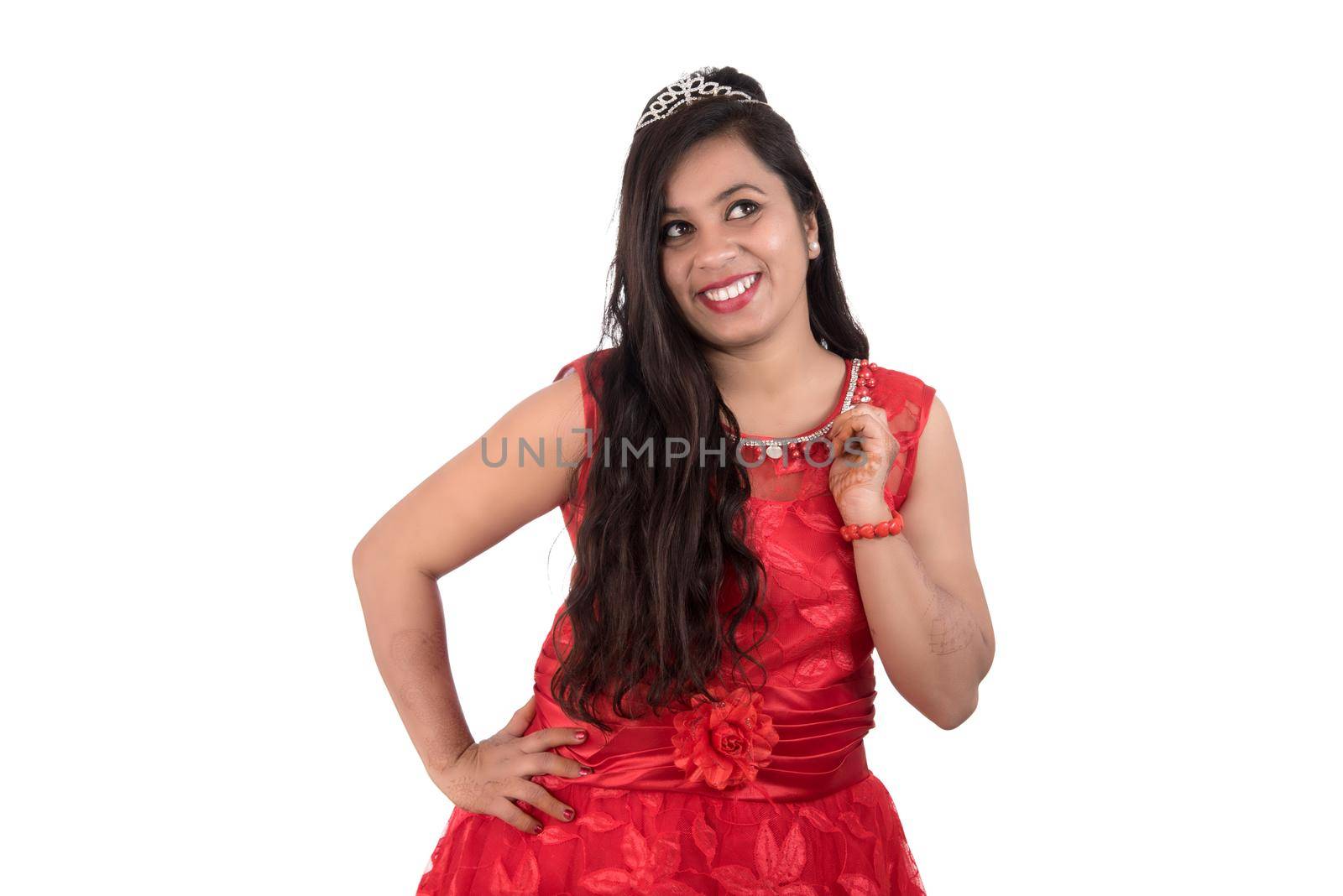 Young girl in red dress posing on white background by DipakShelare