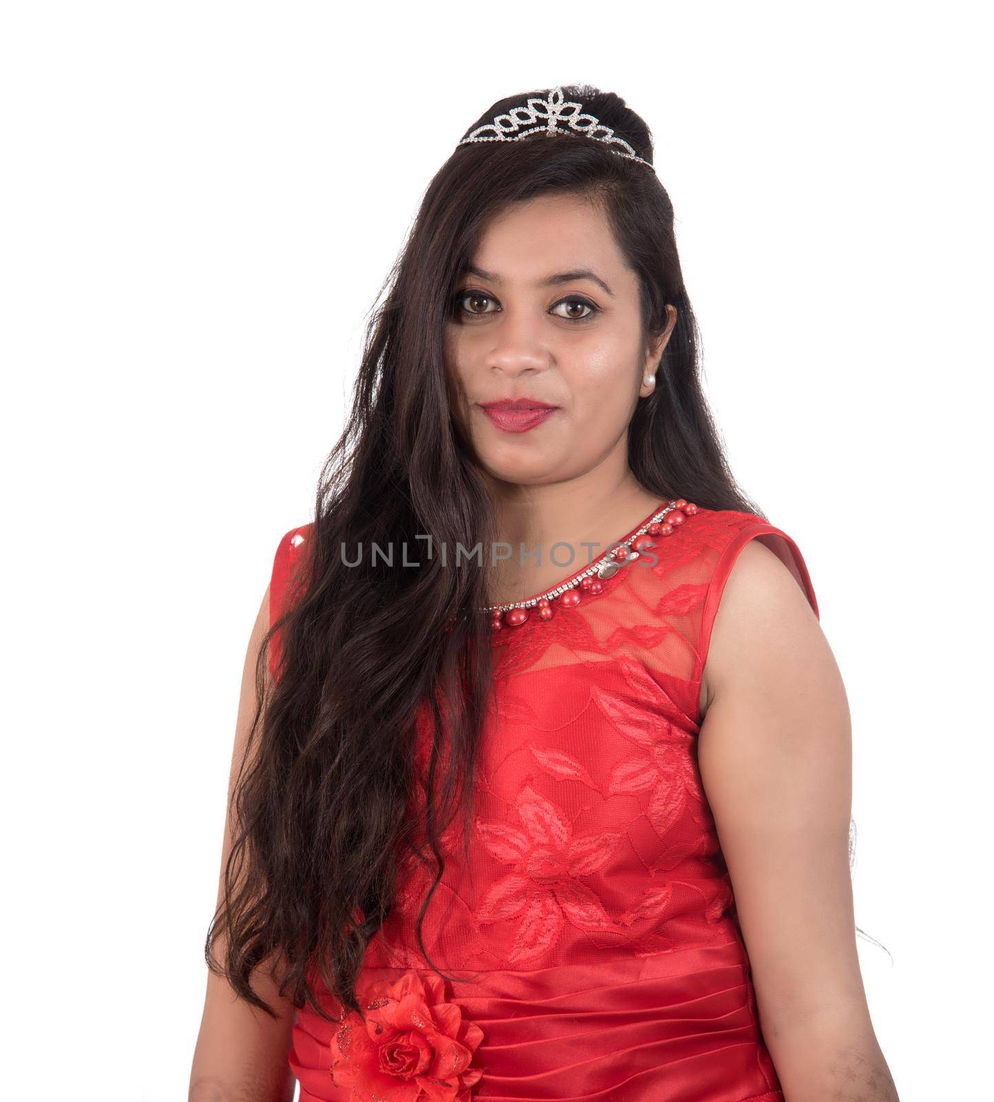 Young girl in red dress posing on white background