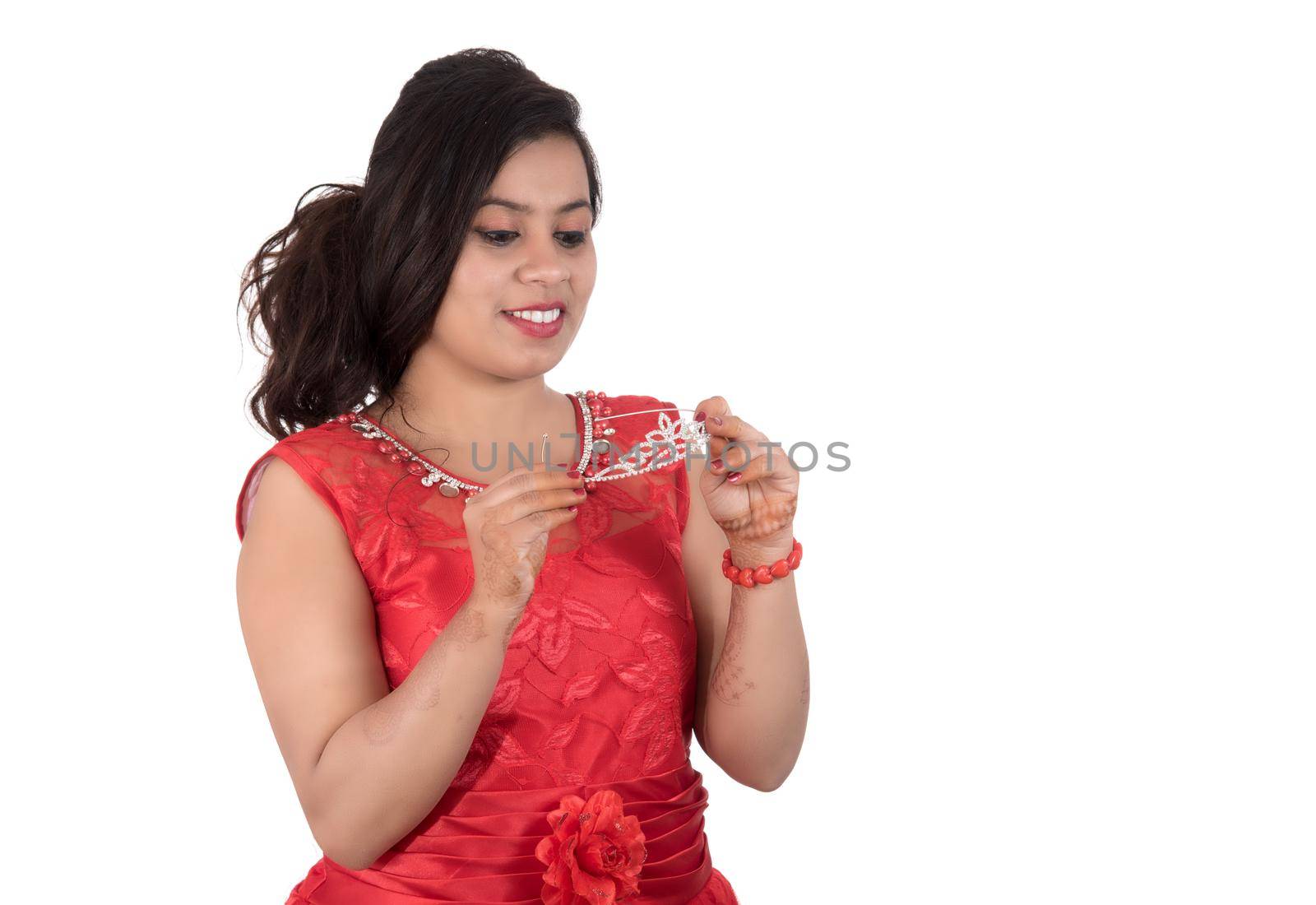 Young girl in red dress posing on white background by DipakShelare