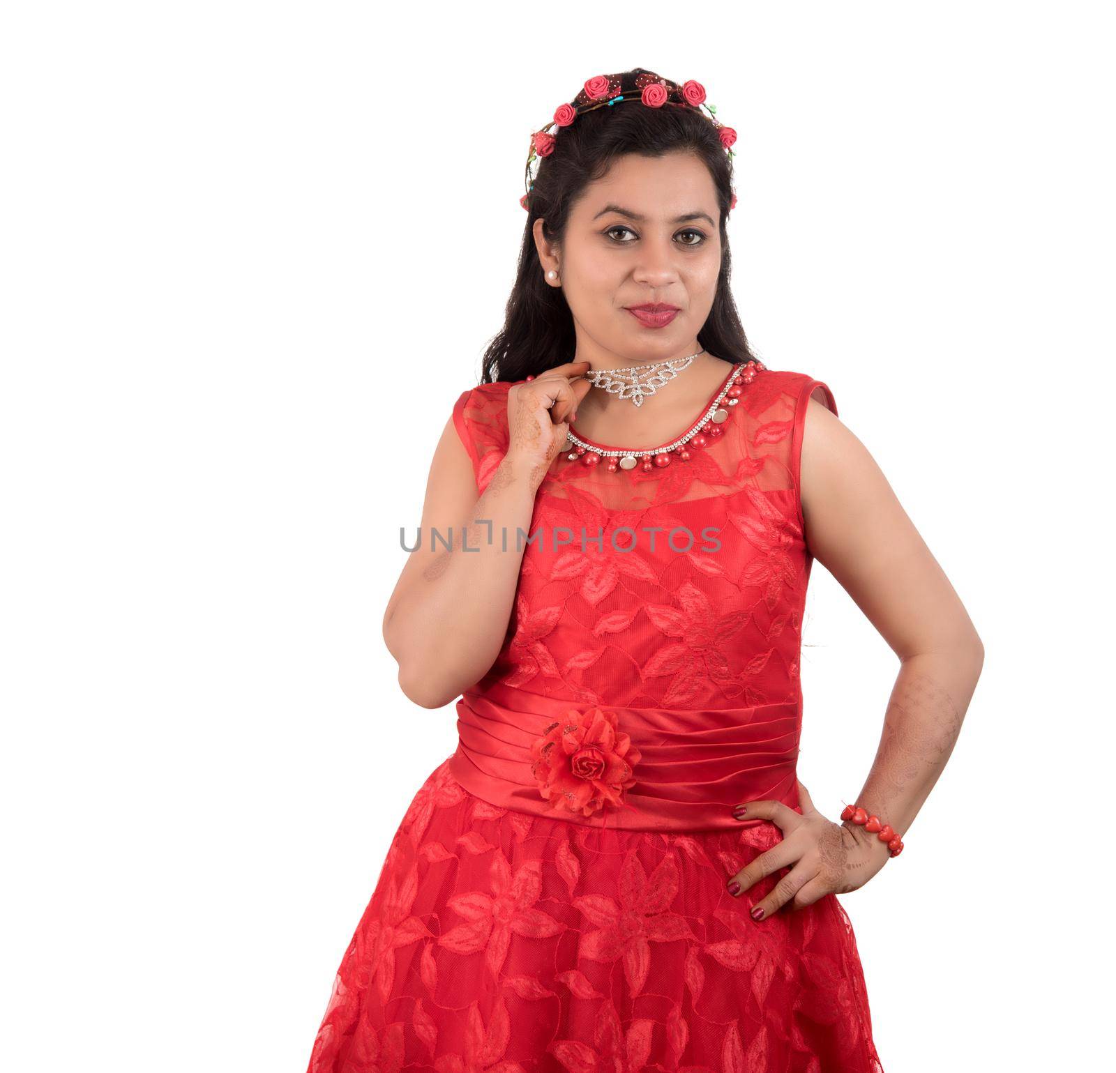 Young girl in red dress posing on white background