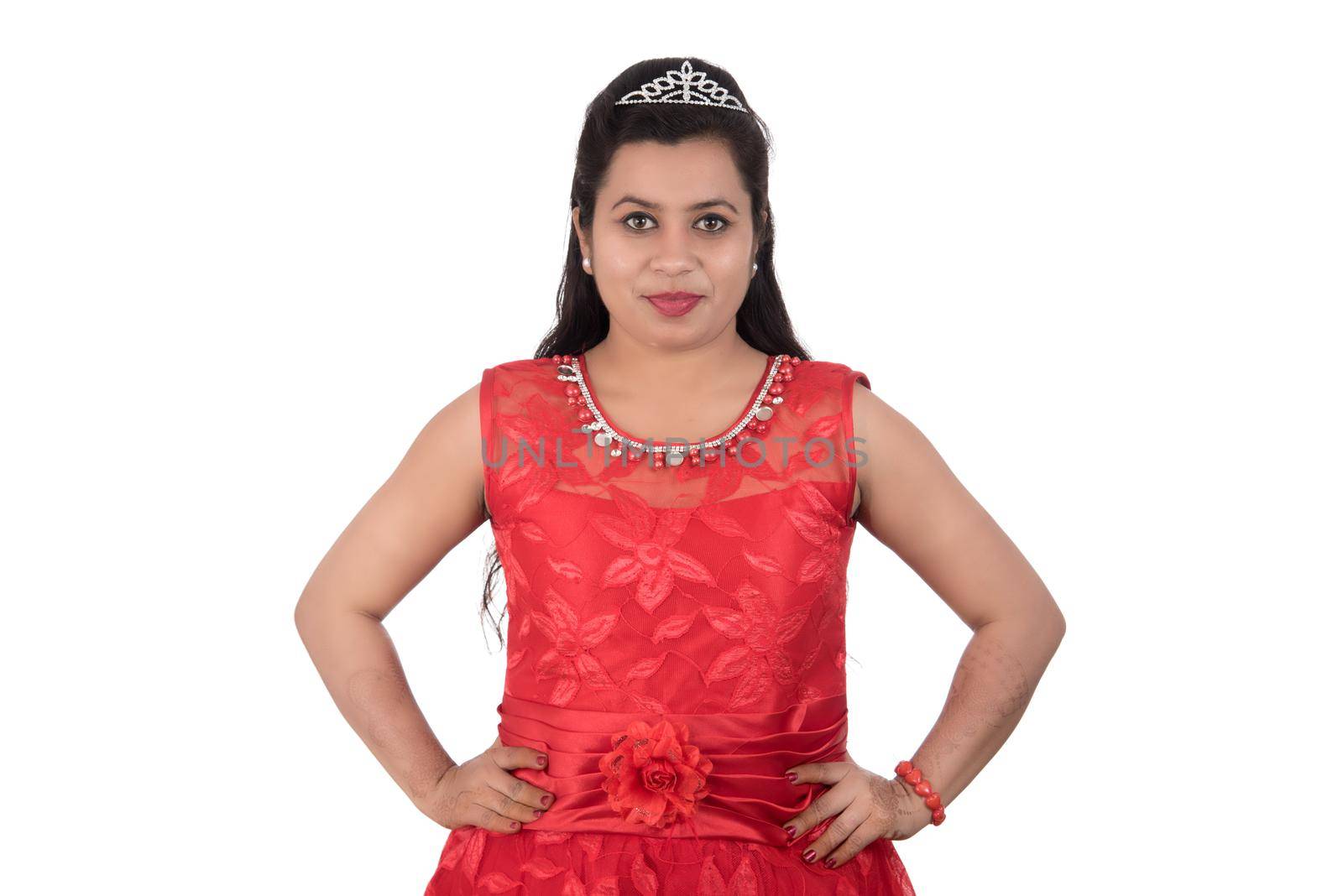 Young girl in red dress posing on white background