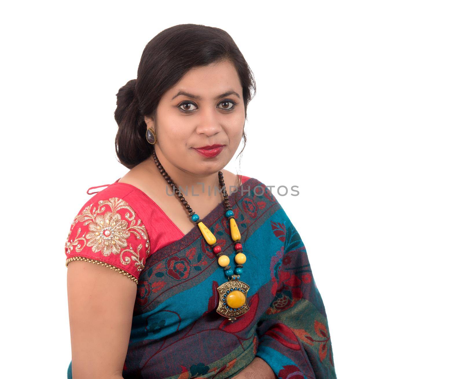 Beautiful young girl posing in Indian traditional saree on white background. by DipakShelare