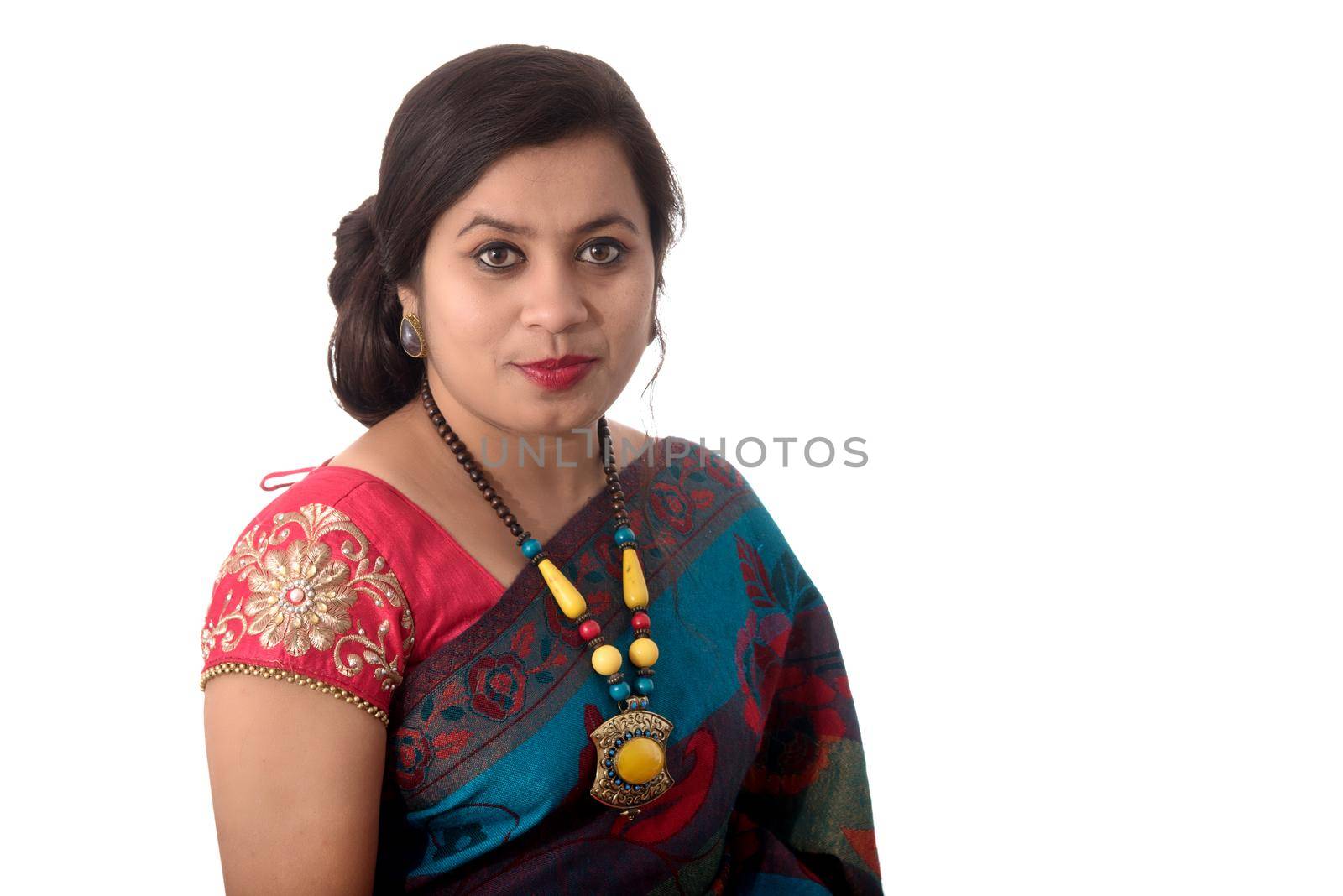 Beautiful young girl posing in Indian traditional saree on white background. by DipakShelare