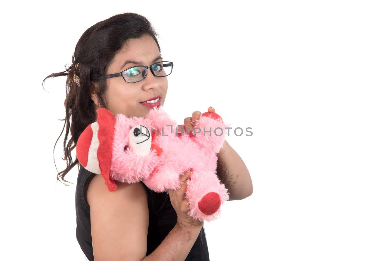 Beautiful young girl holding and playing with a teddy bear toy on a white background. by DipakShelare