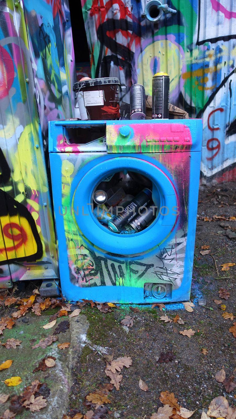 Stockholm, Snosatra, October 28, 2020. A colored washing machine used as a basket to throw away the coloring spray cans used during the day
