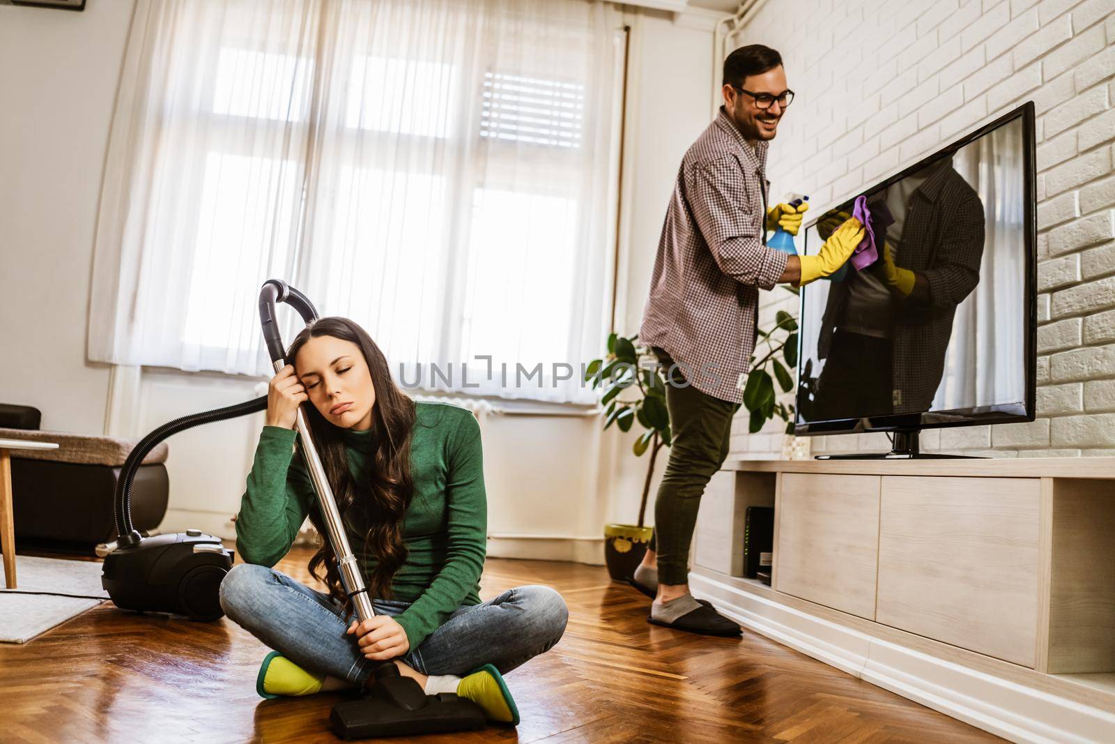 Woman is tired of cleaning the apartment.