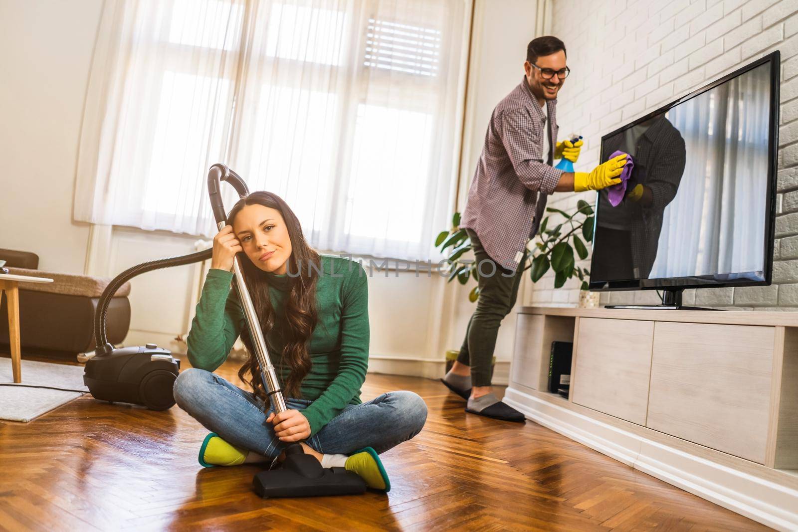 Woman is tired of cleaning the apartment.