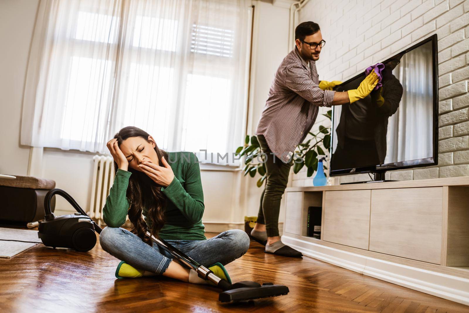 Woman is tired of cleaning the apartment.