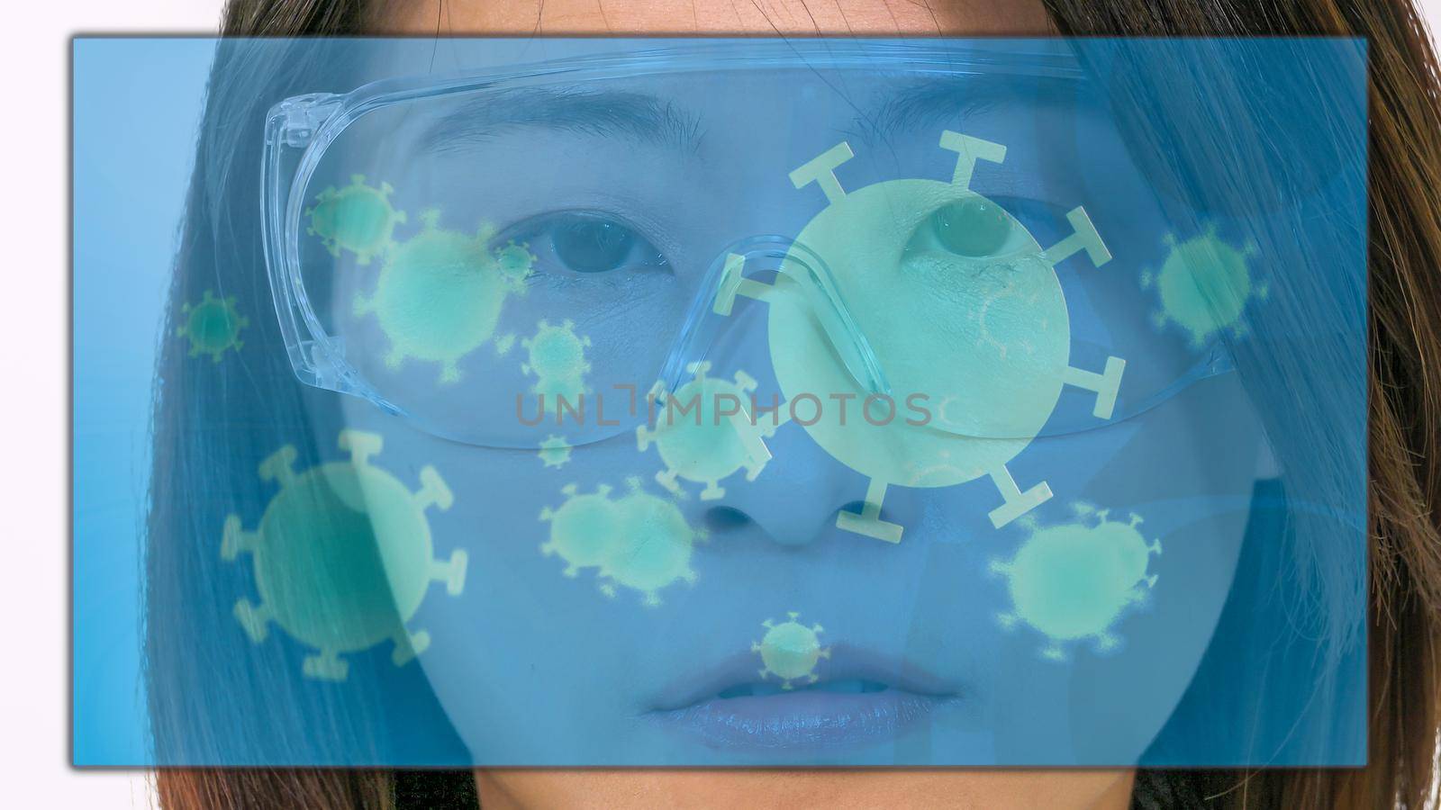 Female Asian American doctor looking at virtual medical screen with coronavirus cells, close-up