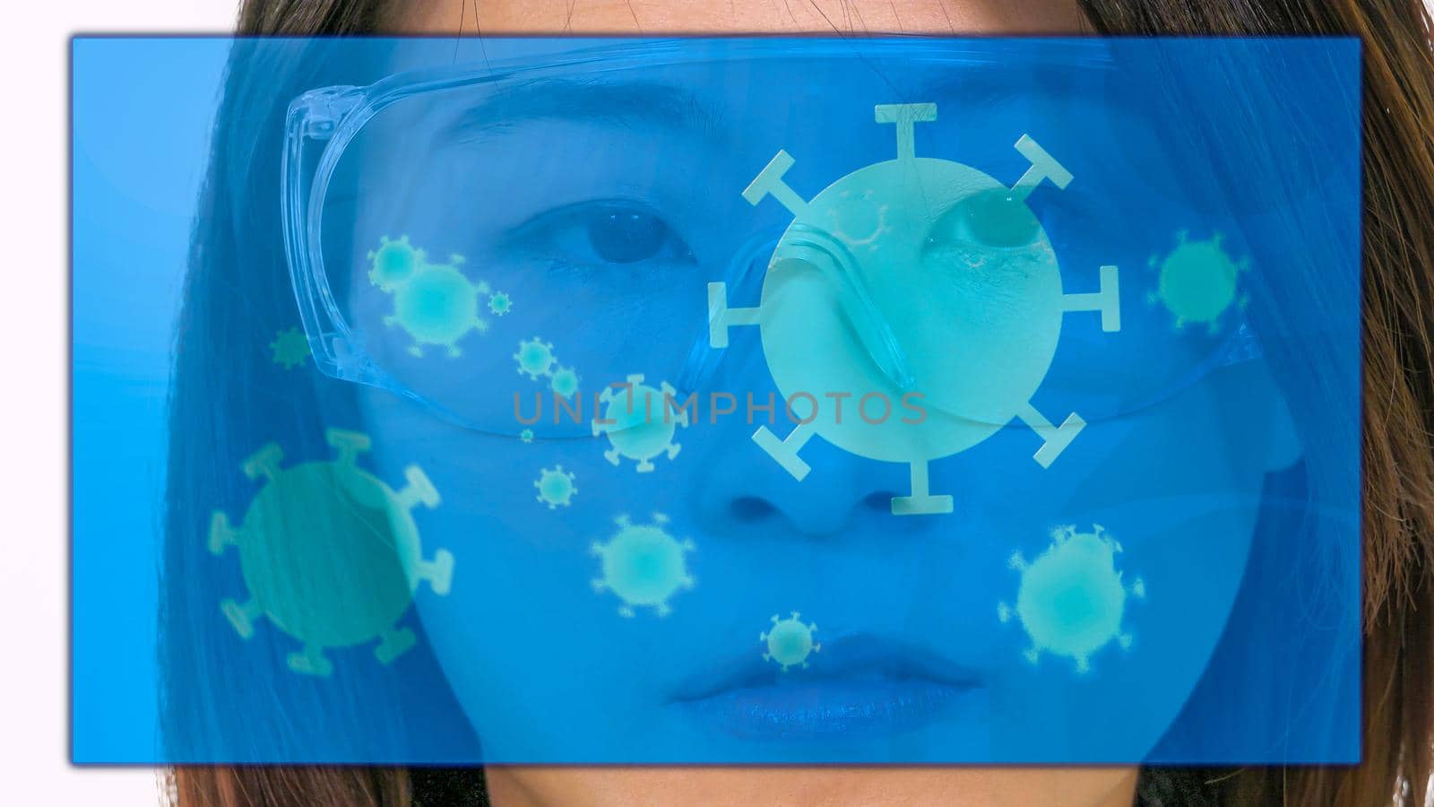Female Asian doctor looking at virtual medical screen with coronavirus cells by imagesbykenny