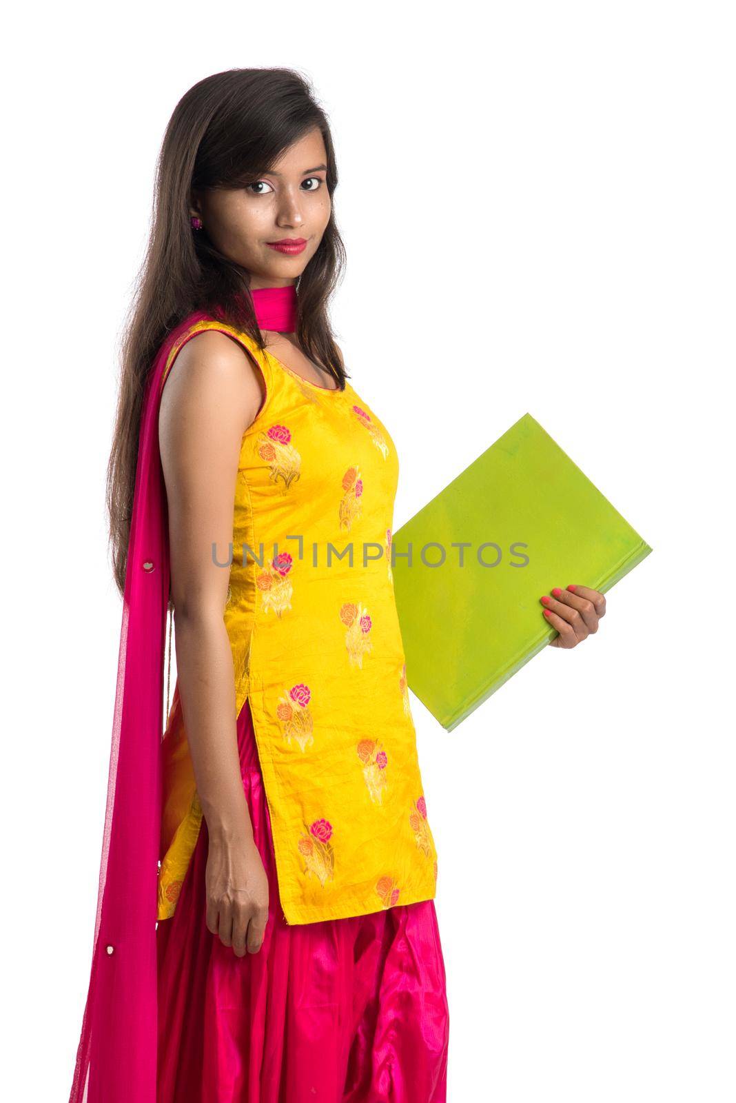 Pretty young girl holding book and posing on white background