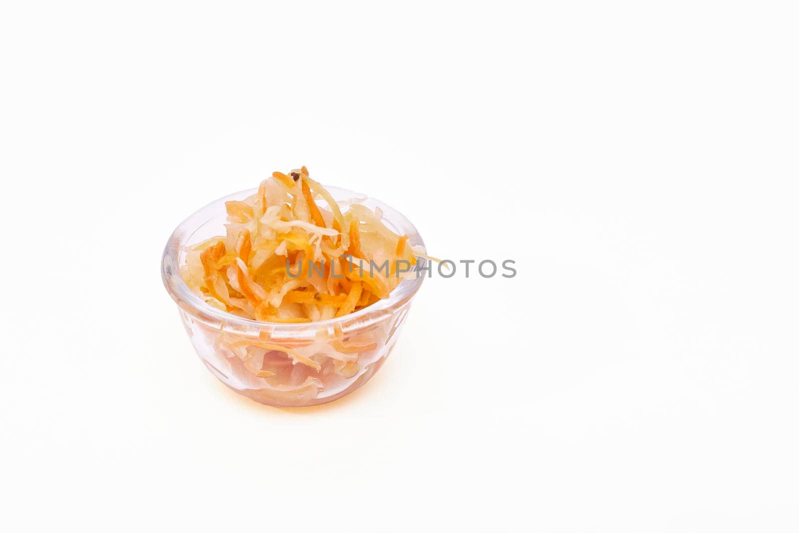 Sauerkraut in a glass bowl on a white background