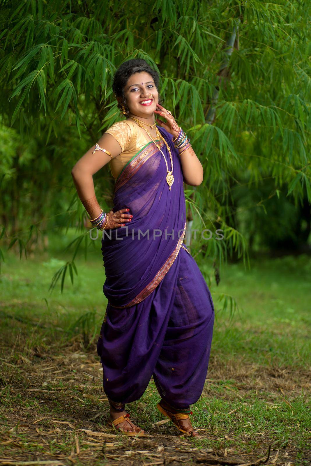 Indian Beautiful young girl in Traditional Saree posing outdoors by DipakShelare