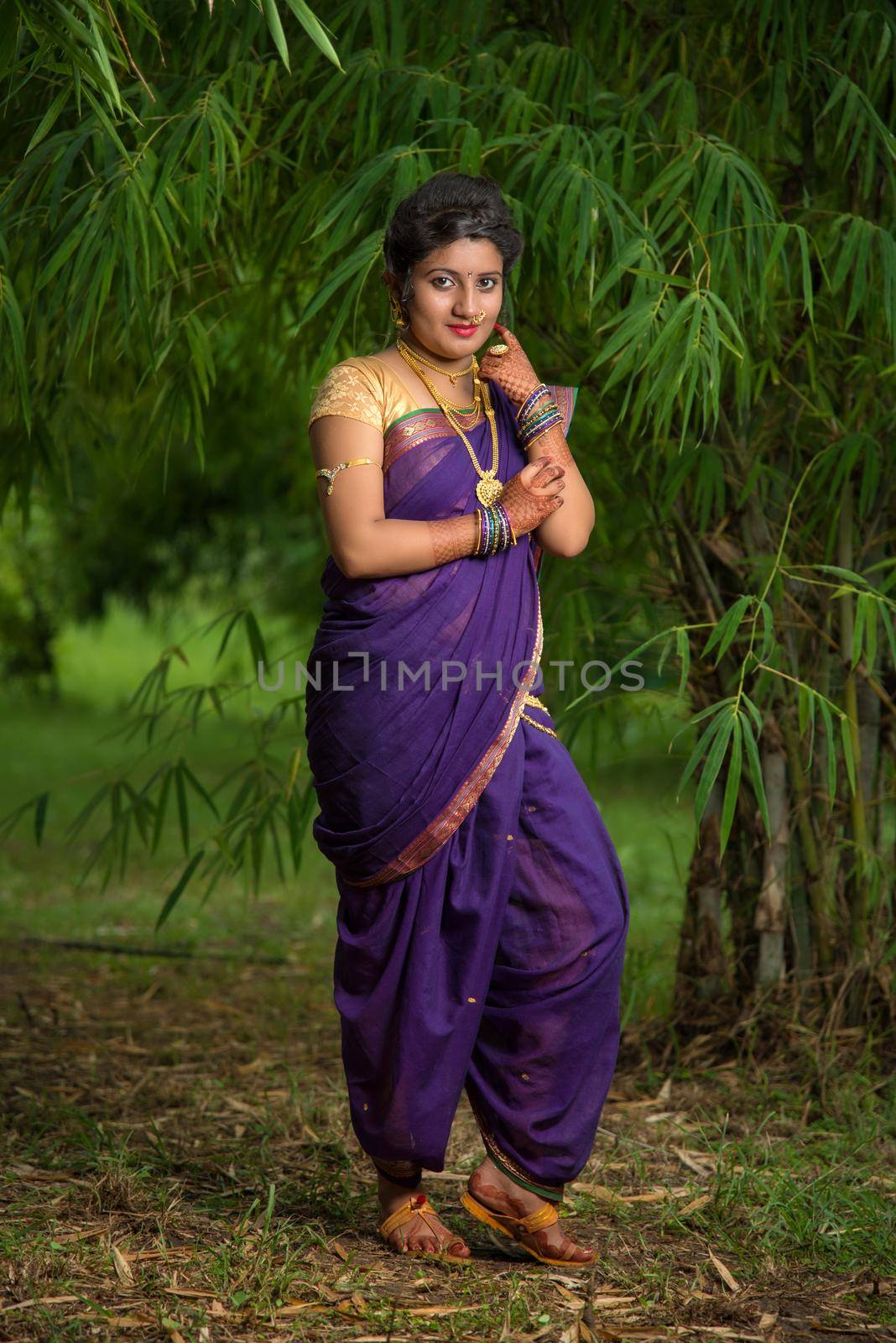 Indian Beautiful young girl in Traditional Saree posing outdoors by DipakShelare