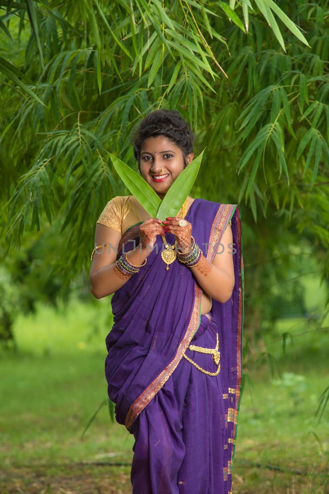 Indian Beautiful young girl in Traditional Saree posing outdoors