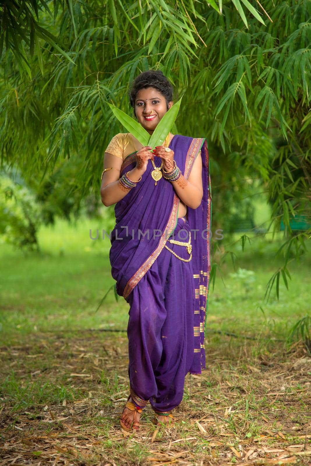 Indian Beautiful young girl in Traditional Saree posing outdoors