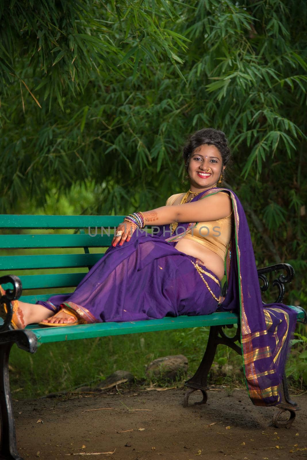 Beautiful Indian young girl in Traditional Saree posing outdoors