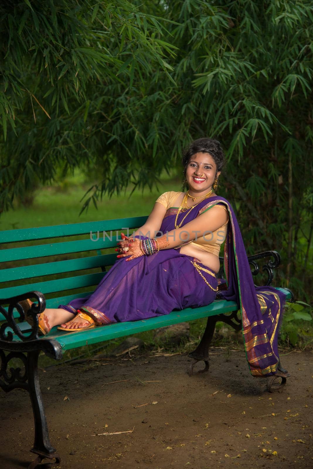 Beautiful Indian young girl in Traditional Saree posing outdoors