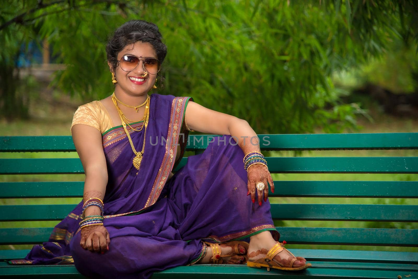 Beautiful Indian young girl in Traditional Saree posing outdoors