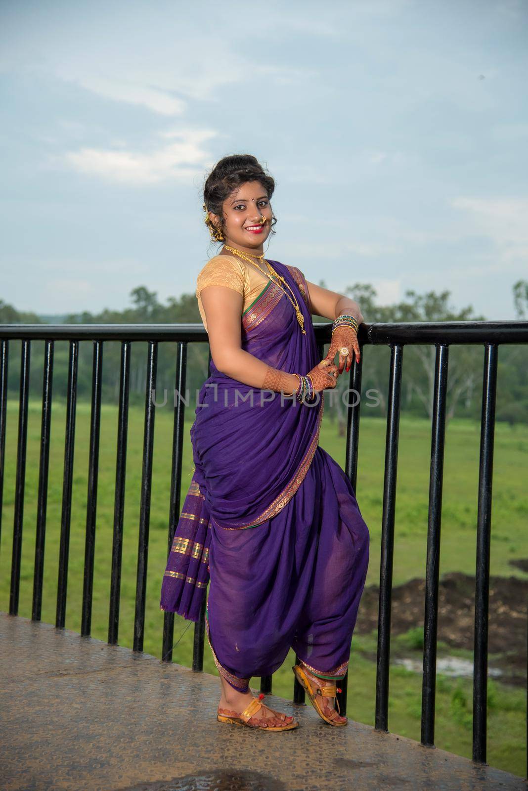 Beautiful Indian young girl in Traditional Saree posing outdoors