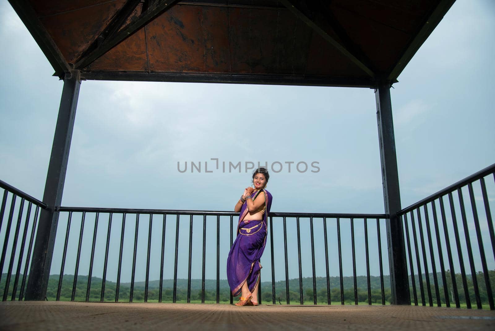 Beautiful Indian young girl in Traditional Saree posing outdoors