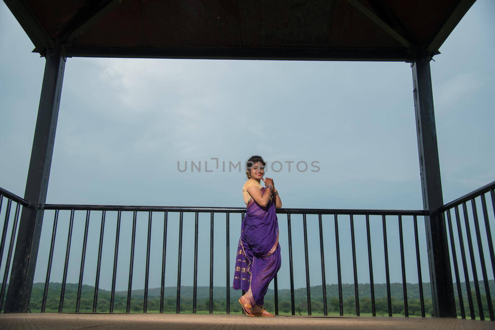 Beautiful Indian young girl in Traditional Saree posing outdoors