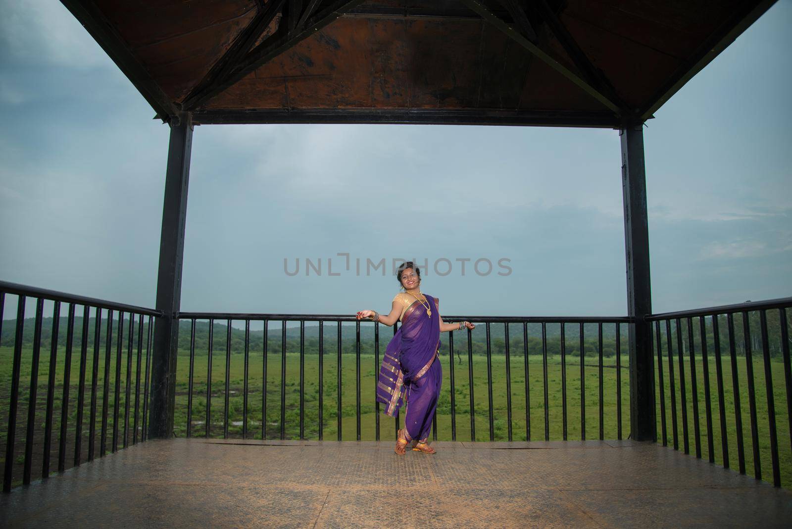 Beautiful Indian young girl in Traditional Saree posing outdoors