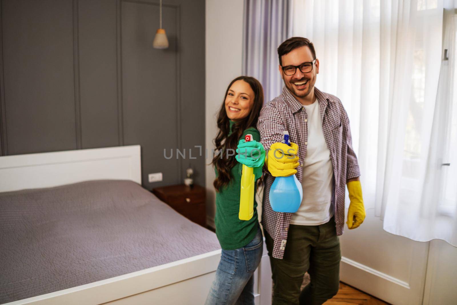 Young happy couple is ready for cleaning their apartment.