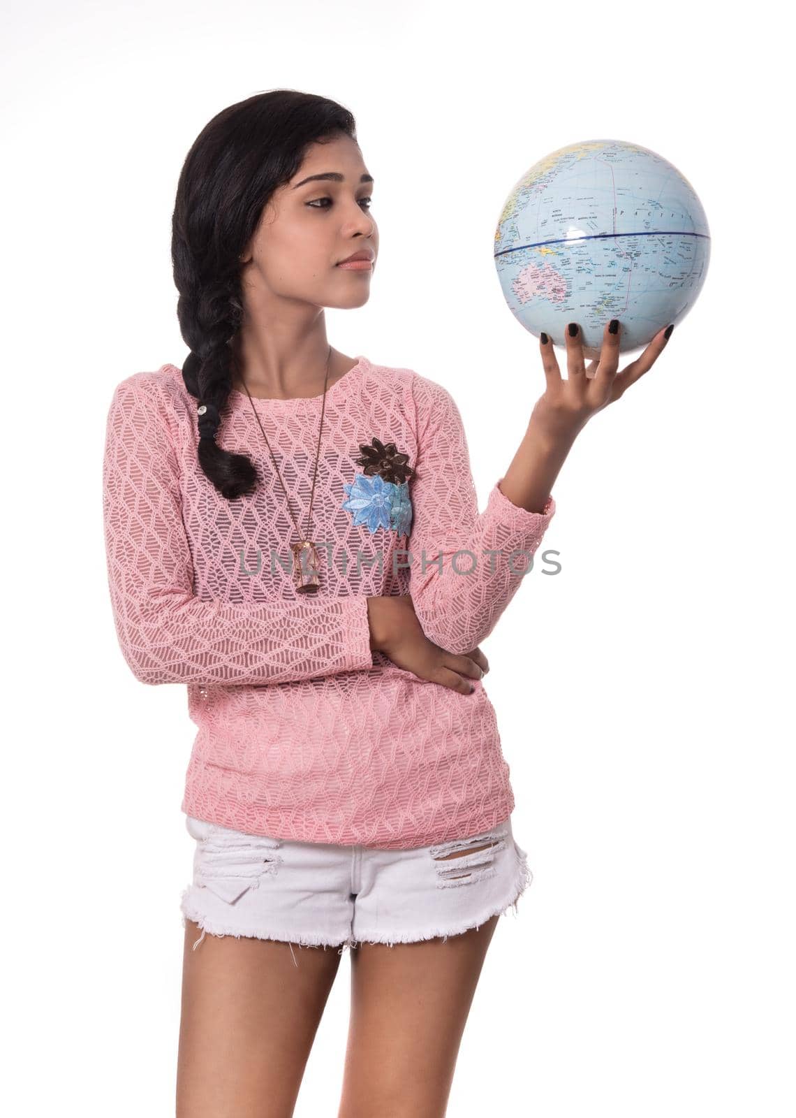 Beautiful Girl holding a world globe isolated on a white background