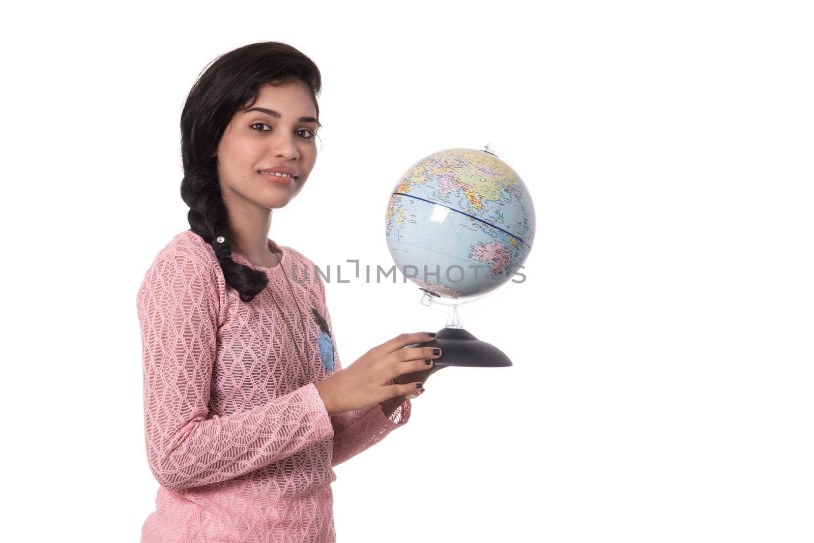 Beautiful Girl holding a world globe isolated on a white background