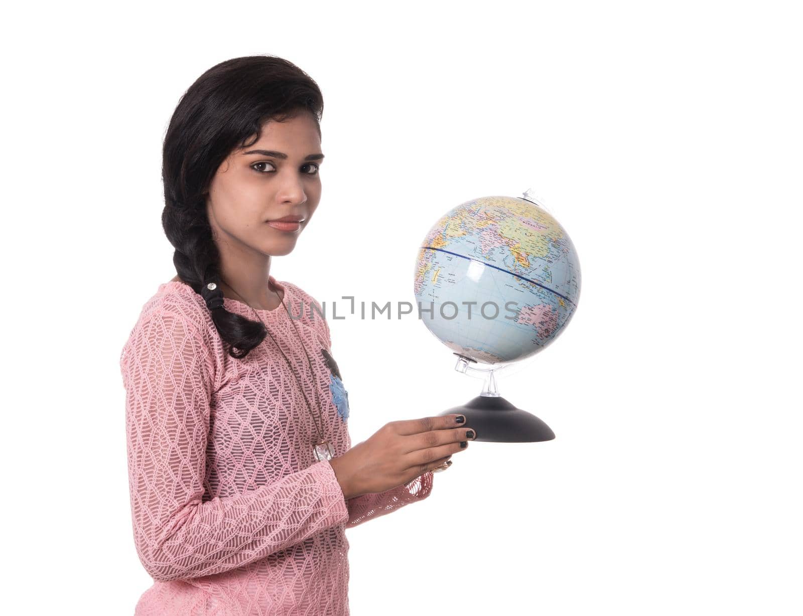 Beautiful Girl holding a world globe isolated on a white background