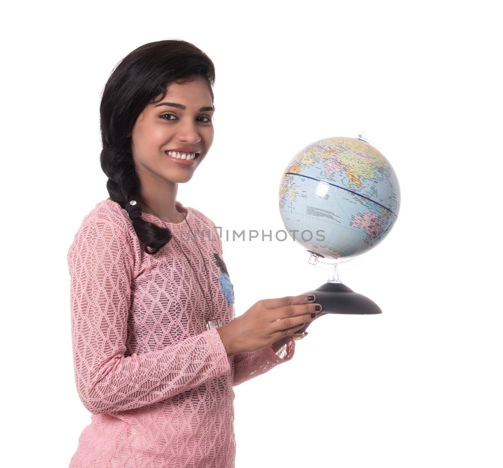 Beautiful Girl holding a world globe isolated on a white background by DipakShelare