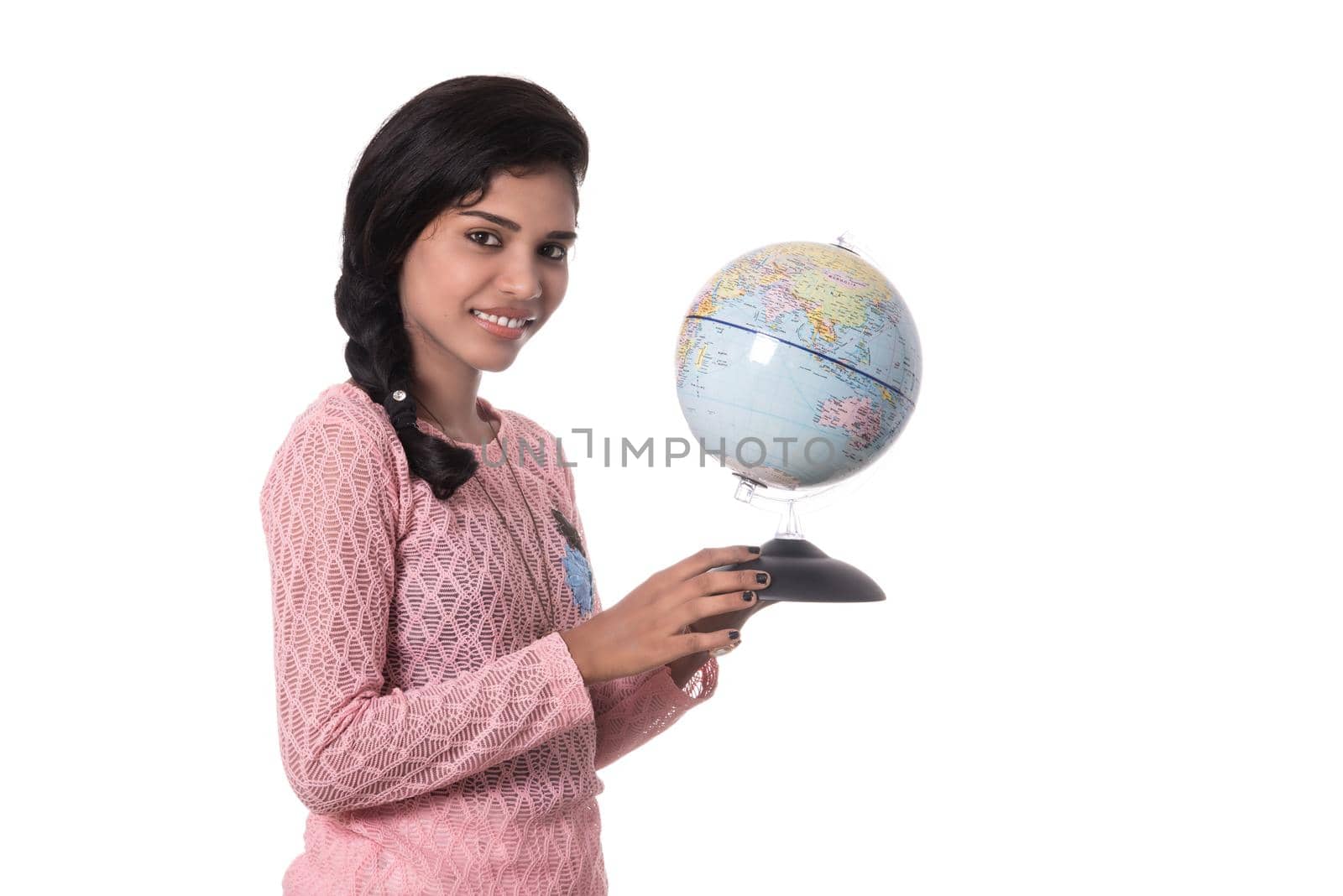 Beautiful Girl holding a world globe isolated on a white background