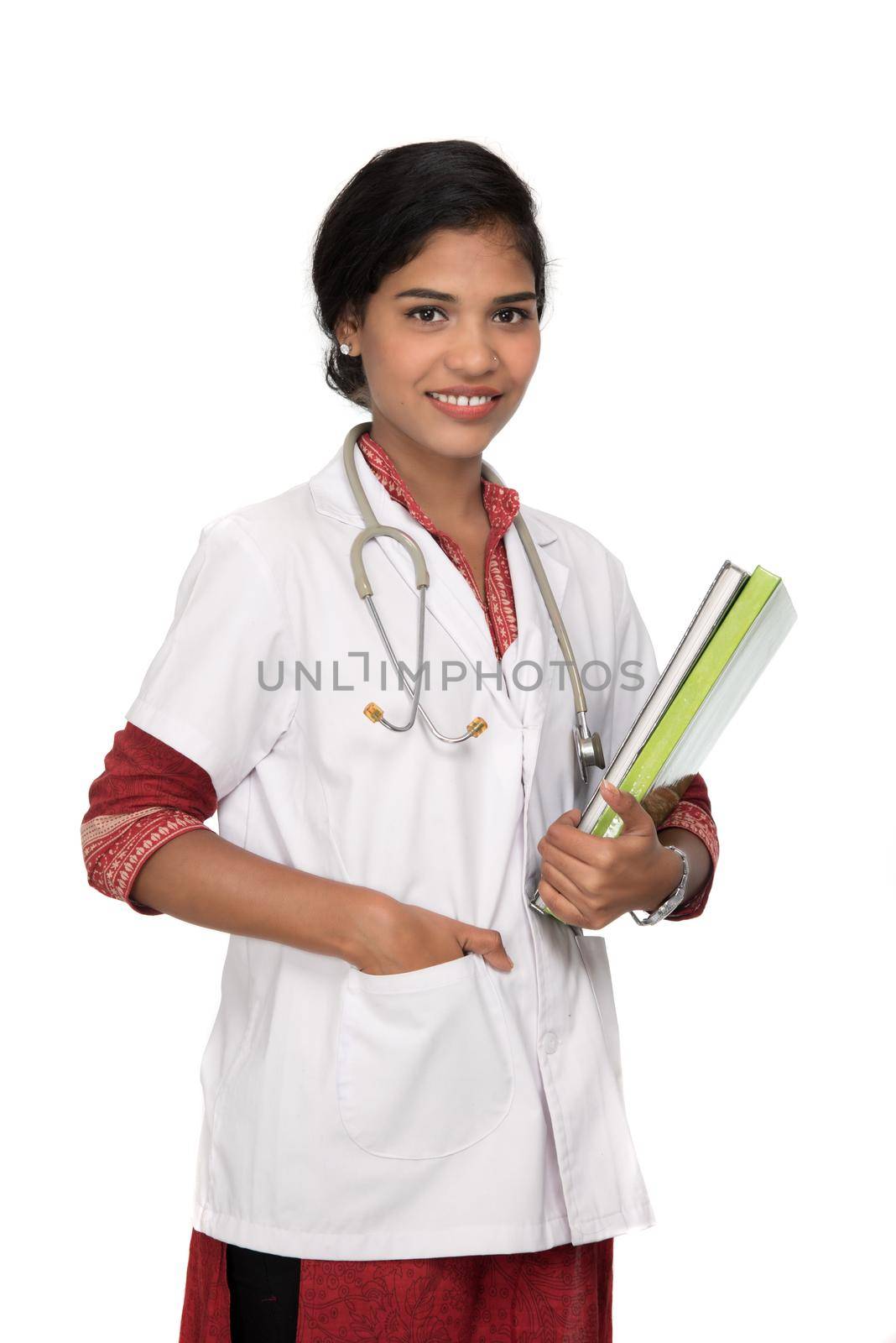 Young woman doctor holding book with stethoscope