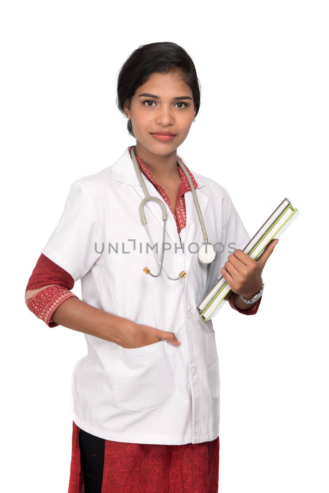 Young woman doctor holding book with stethoscope