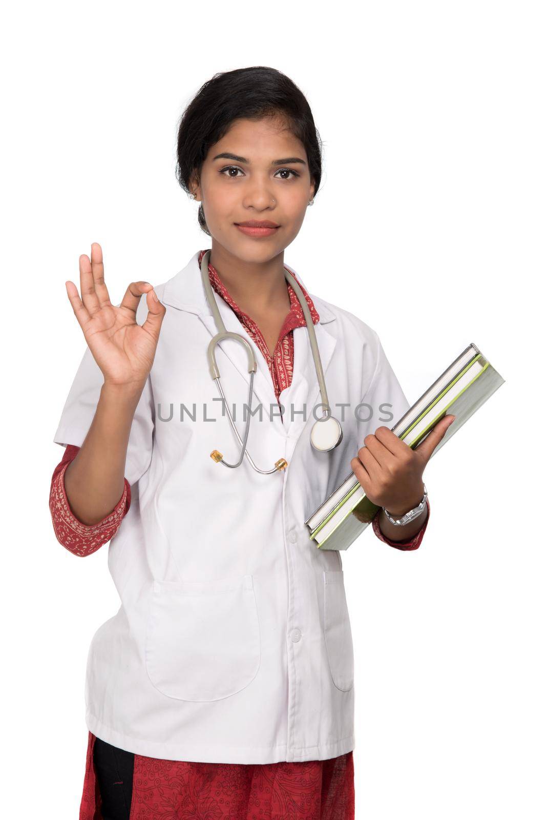 Young woman doctor holding book with stethoscope by DipakShelare