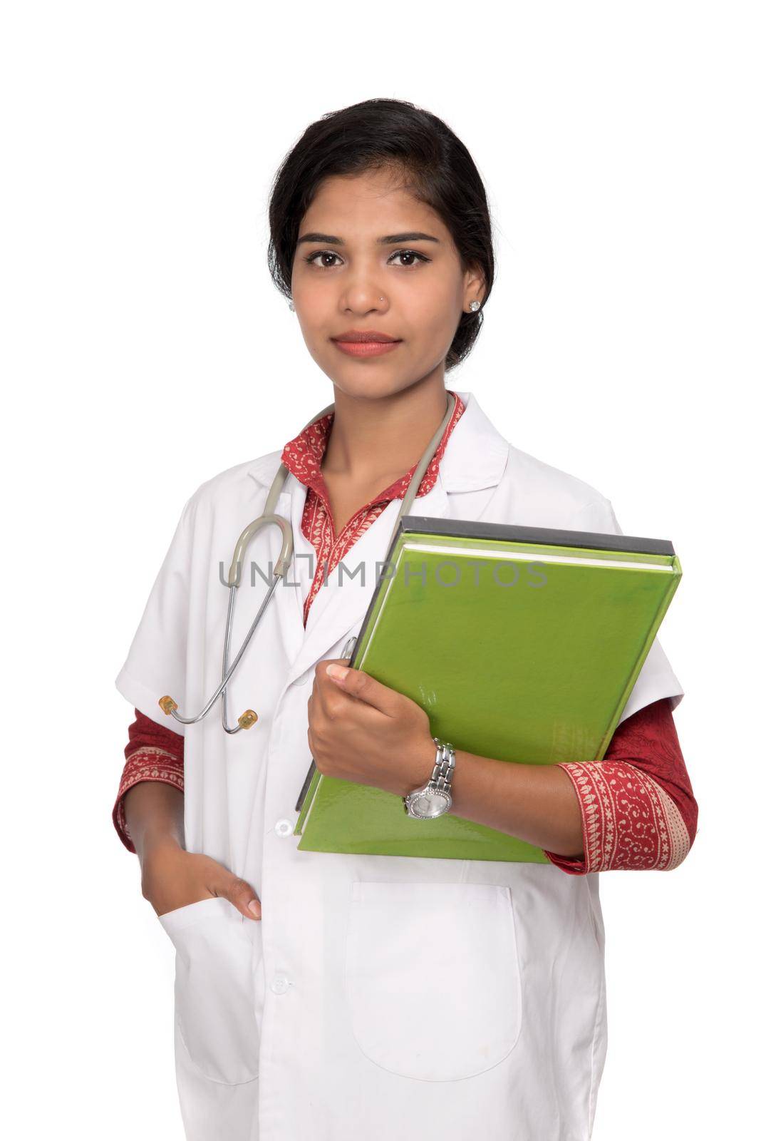 Young woman doctor holding book with stethoscope by DipakShelare