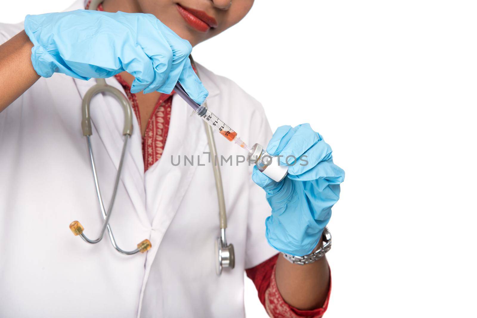 A female doctor with a stethoscope is holding an Injection or Syringe.